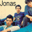A pixelated group photo of four young men in blue shirts on a light background, with text reading 'Jonas Brothers' at the top and a black heart symbol below.