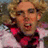 Pixelated image of a person with curly blonde hair wearing glasses and a red bow tie on the left, next to pink background text reading "Jackie and Debra = love".