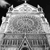 A grayscale pixelated image of a large, rounded, textured object with a flat base and multiple protrusions against a black background.