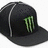 Black baseball cap with green Monster Energy logo on front, displayed alongside green pixelated text reading 'whats tft? a hat' and 'krazy funky junky hat!' in separate sections.