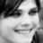 Black-and-white pixelated image of a person with dark hair, showing two views where red text appears above the head in one view.