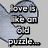 A static image of a light gray puzzle piece with pixelated text reading "love is like an ad puzzle..." and "there is always a missing piece :)" on its surface.