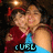 Two pixelated figures in close embrace, one wearing red and blue clothing with visible text 'CUBE' on the chest.