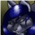 A pixelated blue and gray character with large ears and a shiny head, set against a dark background with subtle green and brown tones.