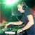 Pixelated image of a person in dark clothing holding equipment with green and white lighting effects on the left, next to bright green text reading "Original Icons .com" on a solid dark background.