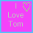 A pink square icon with light gray text reading "I Love Tom" and a heart symbol above the word "Love," bordered by blue. The right side shows partial cropping.