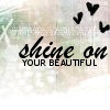 A static icon with handwritten-style text 'shine on' above blocky text 'YOUR BEAUTIFUL', three black hearts floating in the top-right corner, and a blurred light-colored background.