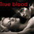 Red pixelated text 'True blood' appears above a grayscale pixelated image of a skeletal figure lying on a surface with a dark background.