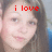 A pixelated image of a person with long brown hair, showing two side-by-side views where text changes from 'i love' to 'lidia'.
