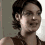 A four- shows a person with short dark hair in a brown sleeveless top, displaying different facial expressions and head positions against a light gray background