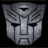 Static pixelated gray robot face icon with symmetrical features and dark eye slits on black background.