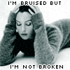 identical grayscale images showing a person lying prone with hands on head, each containing text and pink stars