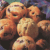 Animated contact sheet of muffin-themed buddy icon frames showing progressive text truncation over a grid of chocolate chip muffins.