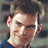 A pixelated image shows a person with light brown hair and blue eyes, wearing a dark blue shirt, next to text reading 'Stifler', 'August 1st', '2003', and a red stamp-like graphic saying 'AMERICAN WEDDING'.
