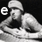 Black-and-white animation of a person in a cap leaning forward with hands clasped, displaying changing text characters around the figure.
