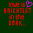 Red pixelated text on dark green background reads 'love is BRIGHTEST in the DARK..' with a pink heart symbol replacing 'is' in the first line.