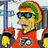 Pixelated character in red jersey with '99' emblem, green-and-orange striped beanie, blue sunglasses, holding yellow object against blurred background; blue with red text 'Duffman!!' and 'drinks beer whenever he can!!'