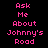 Pixelated pink text on black background reads "Ask Me About Johnny's Road" in three vertical with a gray rectangle in the bottom right corner