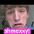 Pixelated close-up of a person's face with brown hair, wearing dark clothing and blue shoulder accents, overlaid by bright pink text reading 'shmeexy!' in white pixel font.