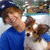 A person in a blue shirt holds a small brown and white dog, with the dog's head turning slightly left to right across frames.