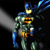 A pixelated figure in a blue and gray suit with yellow and orange chest accents stands against a dark background, emitting a white light from its left side.