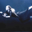 Pixelated static image of a figure in motion against dark blue background with white highlights and gray shadows.