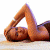 A pixelated image of a person lying on their back with legs raised in an inverted V shape, next to green text reading "Original Icons .com".