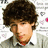 A pixelated image of a person with curly brown hair wearing a light-colored shirt, next to a bright yellow background with green and blue text.