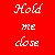 A 2x2 contact sheet of a four-frame animation showing two cartoon bears hugging on the right side, with red background and white text on the left side reading "Hold me close And never let go" in pixelated font.