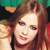 A pixelated close-up of a person with light brown hair, wearing a red garment, against a green and black background.
