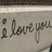 A static image with a light purple background containing multiple text elements and one partial handwritten phrase.