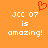 Orange background with white pixelated text reading 'JCC 07 is amazing!' and a red pixelated heart above the text on the left side.