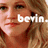 Pixelated close-up of a person's face with visible eyes, nose, mouth, and hair; white text overlay reads 'bein.' in lowercase letters.
