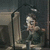 A pixelated image shows a person seated at a desk with a computer monitor, lamp, and books in a dimly lit room; adjacent text reads "Charlie Jones".