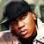 Two side-by-side pixelated portraits of a person wearing a dark cap and light-colored shirt, with one portrait showing the face turned left and the other right.