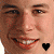 A pixelated face with a black heart icon on the left cheek and yellow heart icon on the right cheek in adjacent frames.