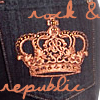 A static icon featuring a golden crown with intricate detailing, set against a dark background with orange script text above and below.