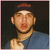 Pixelated image of a person in blue shirt and dark cap with red logo, next to neon purple text on black background.