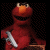 A 2x2 contact sheet of a pixelated Elmo character holding a silver handgun across four frames with text reading "Elmo Gone Wild!" on the right side.