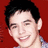 A pixelated image of a person with short dark hair against a solid red background, wearing a light-colored checkered shirt.