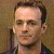 A pixelated image of a person with short dark hair against a brown background, next to green text reading 'Original Icons .com' on a solid green field.