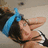 A pixelated image of a person with dark hair and a blue headband lying down, with blue text reading "i love you" and "baby" on black backgrounds.