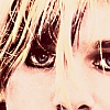 Close-up of a person's face showing eyes, nose, and hair with visible pixelation and color distortion.
