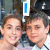 Two people pose together in a of four with blue text overlays changing across frames