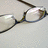 A pair of eyeglasses with dark frames and clear lenses appears in a static image with the word 'Geek' below.