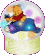 A snow globe containing Winnie the Pooh in a red shirt and blue pants, with colorful circular shapes inside.