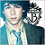 A pixelated image of a person in blue and white clothing with dark hair, featuring two versions: one without text overlay and another with "NICKK" and "<3" text overlays.