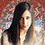 A 50x50 pixel animated buddy icon featuring a woman with long dark hair on the left and green text reading "Original Icons .com" on the right against a solid green background.