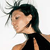 Pixelated profile view of a person with dark hair tied back, wearing a black sleeveless top over a white undershirt, against a plain white background.
