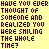 A yellow background displays repeated text in black and red pixelated font, with small smiley faces appearing at the bottom right of each